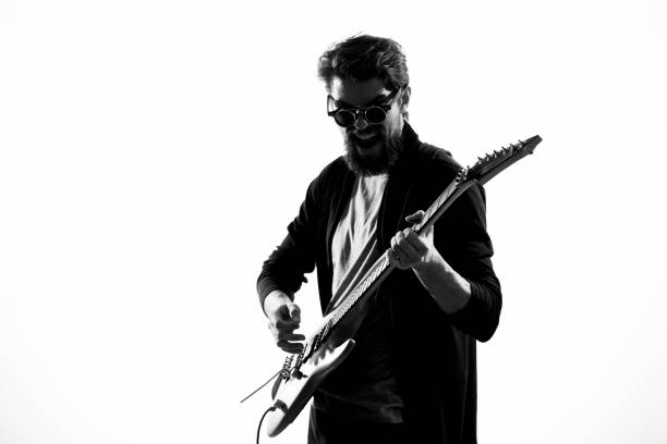 one african man guitarist bassist player playing in studio silhouette isolated on white background