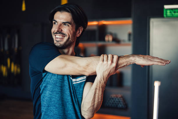 istock Confident young male athlete working out in a gym. 2111590203