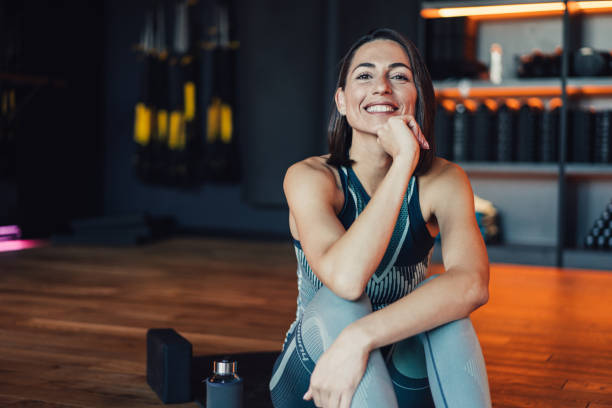 istock Confident young woman working out in a gym. 2111590206
