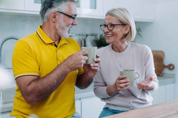 istock Lovely couple drinking coffee at home. 2111592848