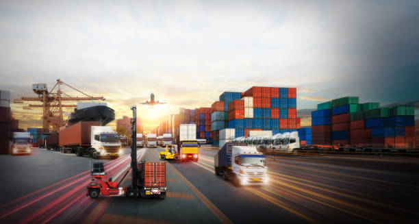 istock Logistics and transportation of Container Cargo ship and Cargo plane with working crane bridge in shipyard at sunrise, logistic import export and transport industry background 2111598631