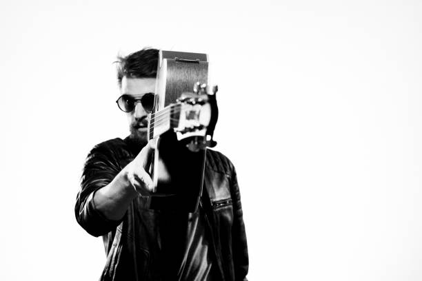 istock A man with a guitar black leather jacket light background performing a musician 2111600718