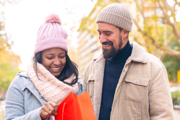 istock Happy young couple outdoors looking shopping 2111601792