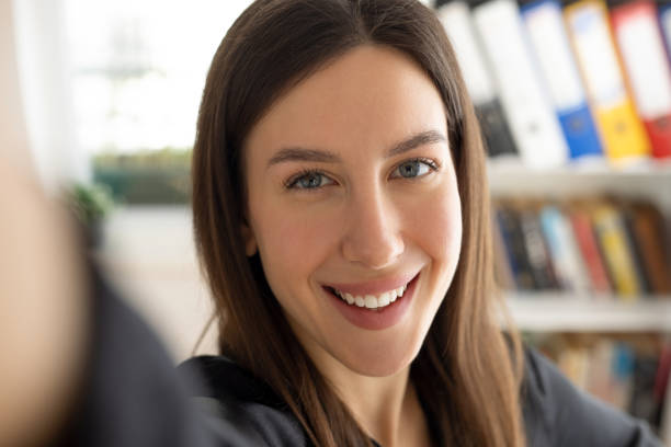 istock Woman taking a selfie at office 2111652207
