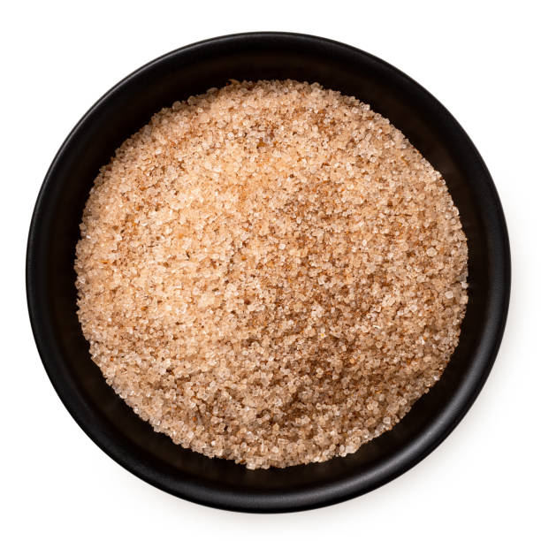 istock Cinnamon sugar in a black ceramic bowl isolated on white from above. 2111663967