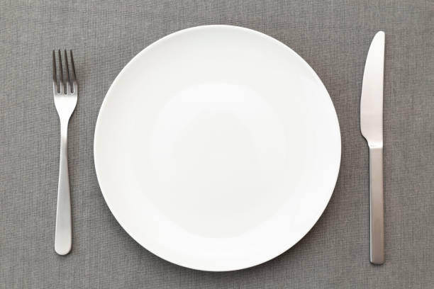 White plates and cutlery on the placemat.