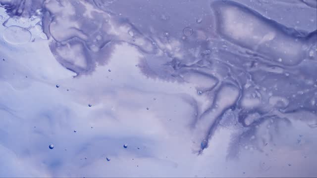 Dissolving liquids in a violet solution, abstract shapes and graphics.