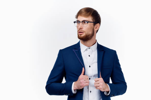 istock blond man in classic suit straightens jacket sleeve cropped view 2111683901