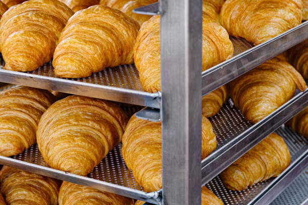 istock Fresh croissants on a steel kitchen rack 2111689168