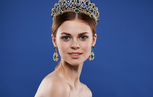 princess with crown on her head and earrings makeup. High quality photo