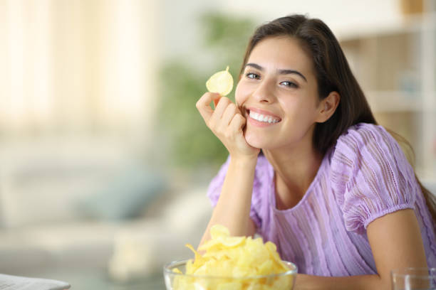 istock Happy woman posing holding potato chip 2111731906