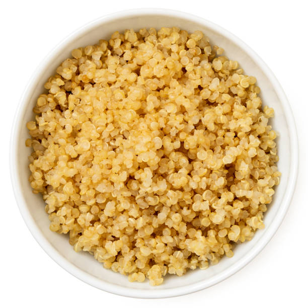 istock Cooked white quinoa in a white ceramic bowl isolated on white from above. 2111739677