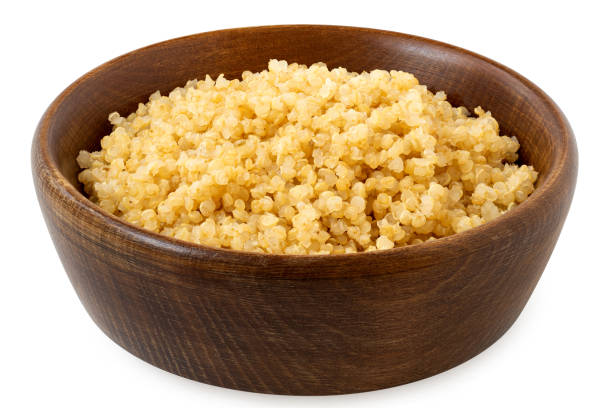 istock Cooked white quinoa in a dark wood bowl isolated on white. 2111742788