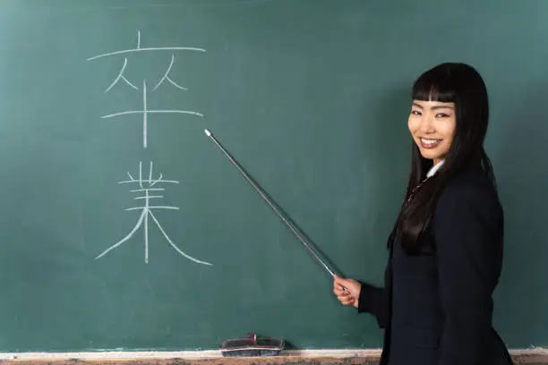 Photo of High school girl standing at the podium (talking about graduation)