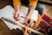 Human hand's teaching man to play guitar