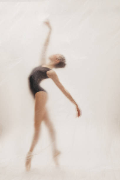 istock Beautiful ballerina dancing on the stage 2111756524