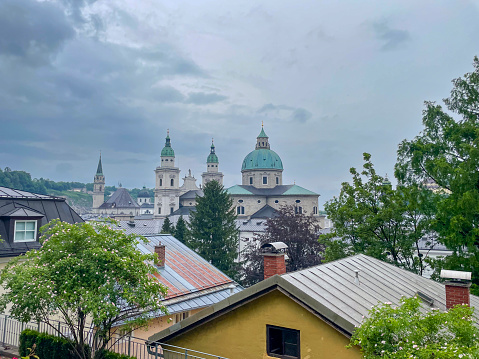 High angle view over the old Town of Salzburg, Austria during an overcast springtime day. Salzburg's historic center (German: Altstadt) is known for its typical Baroque architecture and is one of the best-preserved downtown districts north of the Alps.