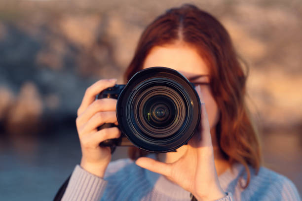 istock woman with professional camera outdoors in mountains front view 2111764970