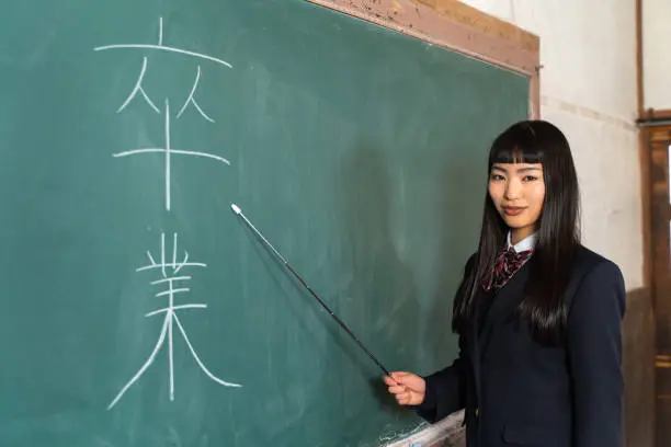 Photo of High school girl standing at the podium (talking about graduation)