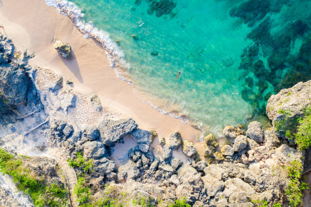 istock Bali - White Sandy Beach with Turquoise Waters and Rocky Cliffs: A Tranquil Coastal Landscape. 2111768635