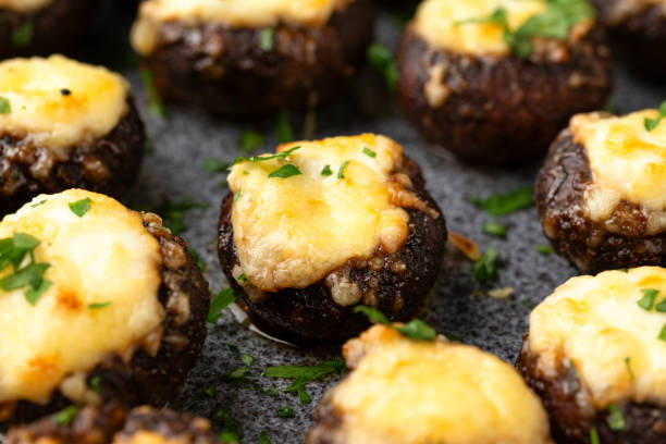 istock Baked stuffed mushroom with cheese, herbs and cream cheese. 2111768648