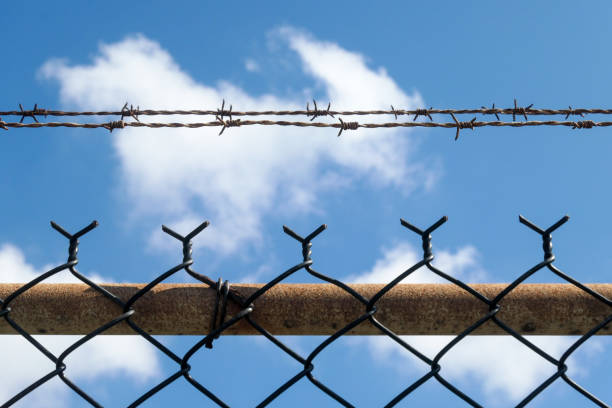 Part of the security fence around the Airservices Australia complex near Sydney Kingsford-Smith Airport.  This image was taken near Kyeemagh Beach, Botany Bay on a hot and sunny morning on 24 March 2024.