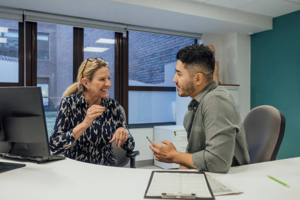 istock Hospital Reception Staff Chatting Together 2111796307
