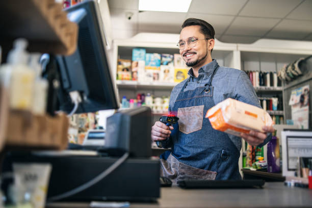 owner checking inventory at store with bar code reader - bar code retail bar code reader food - fotografias e filmes do acervo