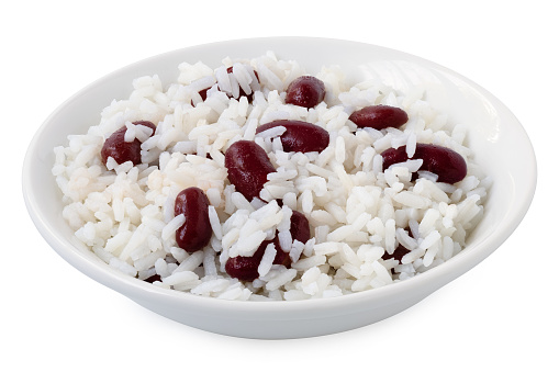Cooked white rice with red kidney beans in a white ceramic bowl isolated on white.