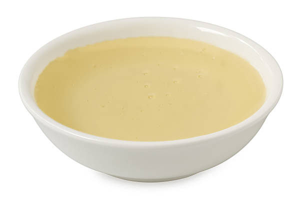 istock Rice syrup in a white ceramic bowl isolated on white. 2111817050