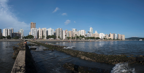 Santos city, Brazil. 03.19.2024. Panoramic view of water channel nº6, the beach, the buildings along the waterfront in the Ponta da Praia neighborhood. 54 megapixels.