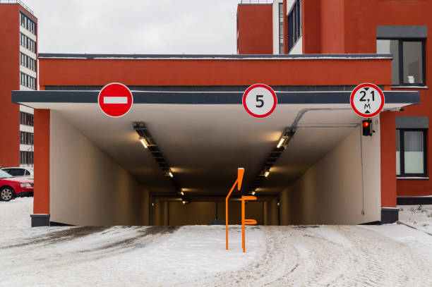 The entrance of the parking lot is illuminated on the concrete wall
