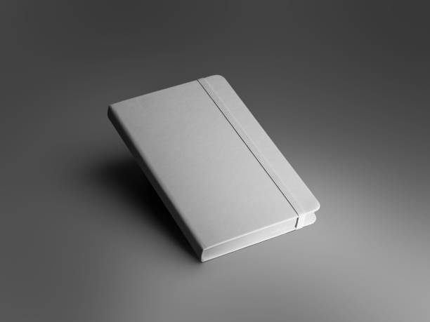 istock Mockup of a textured white closed notebook with an elastic band, diary with a hard cover, isolated on a background with dark shadows. 2111871710