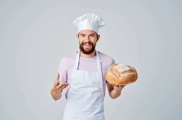 istock man in chef's uniform cooking food baking cooking 2111876050