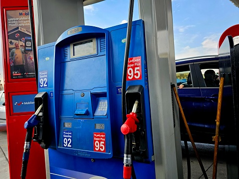 Cairo, Egypt, March 24 2024: gas service station with filling gun pistols, digital unit price and liters meter device, filling nozzles set device, fuel and petroleum price concept, selective focus