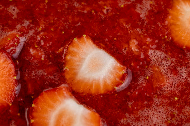 istock juice and pieces of strawberries after pressing 2111878873