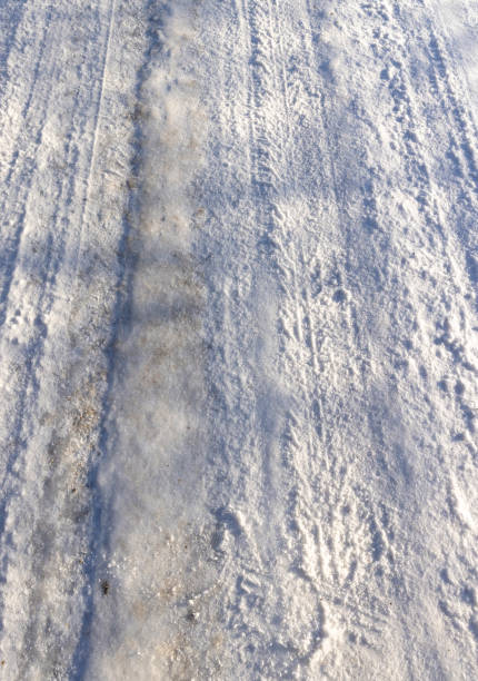 istock wheel tracks on an ice- and snow-covered highway 2111879423