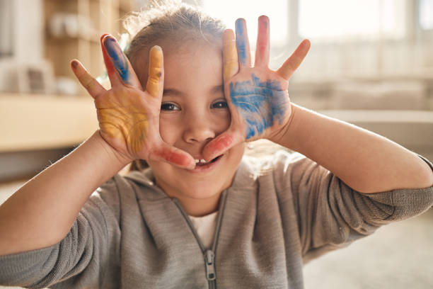 istock Beautiful happy girl with painted hands 2111880051