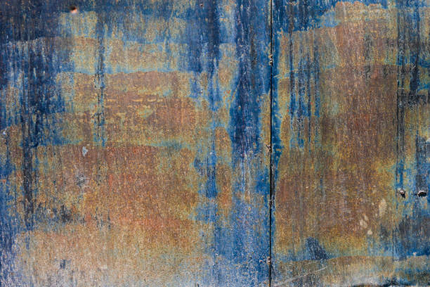 rough dark-blue sun faded flat vertical sheet metal surface with thin rust - full-frame background and texture