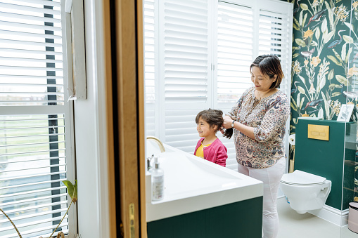 Asian mother and daughter preparing for work and school