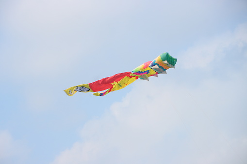 Colorful kite flying in the clear blue sky in summer in Mekong Delta Vienam. Happy childhood moments.