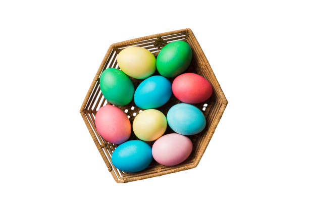 Basket of colorful Easter eggs isolated on white background. Easter basket filled with colored eggs top view holiday concept .
