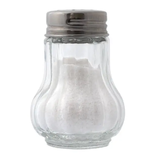 Sea salt in a glass salt shaker isolated in white.