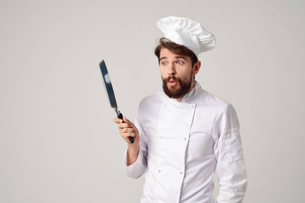 istock bearded man chef with a frying pan in hand light background 2111922242