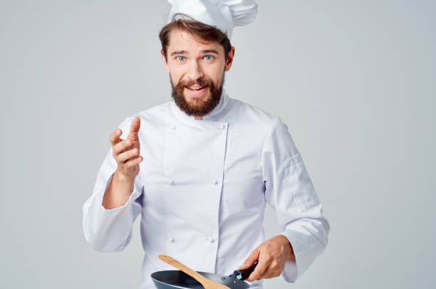 istock chefs with a frying pan cooking food restaurant kitchen emotions 2111926432