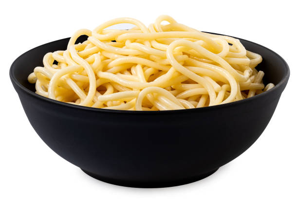 istock Cooked spaghetti in a black ceramic bowl isolated on white. 2111927979
