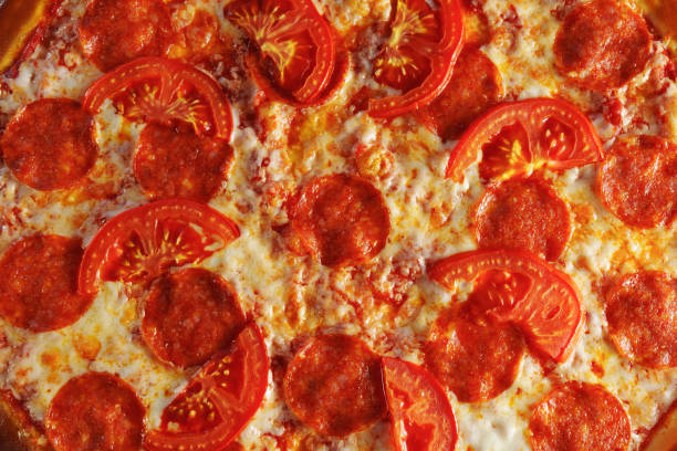 Delectable Pepperoni and Tomato Pizza on Wooden Board. Texture