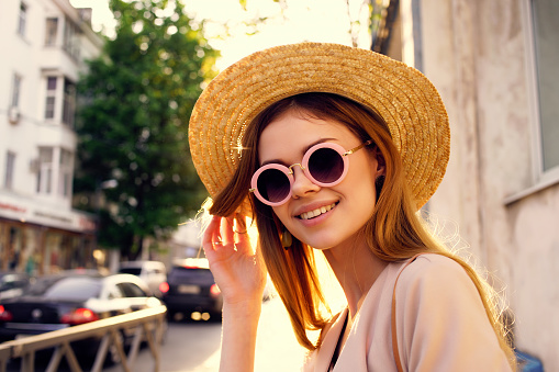 beautiful woman on the street wearing hat and glasses Lifestyle. High quality photo