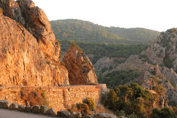 Mountains and  gigantic rocky hills on the left side of the road, Corsica, France