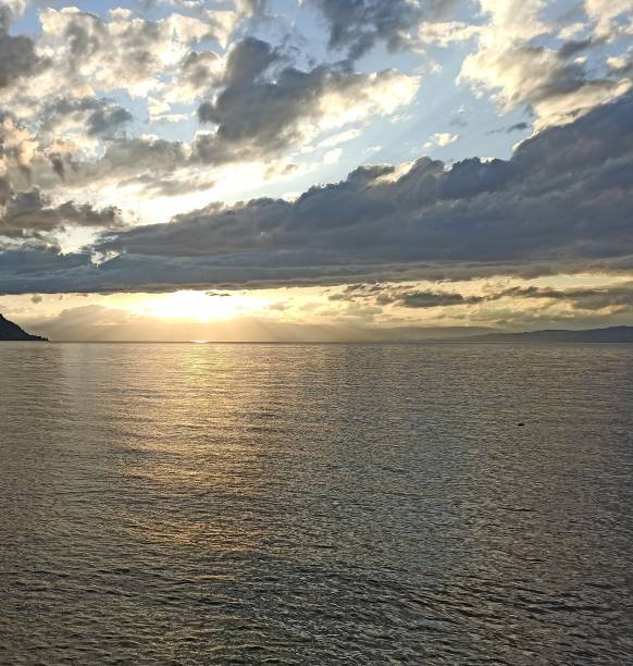 istock Sun rays in the sunset over the lake 2111995385